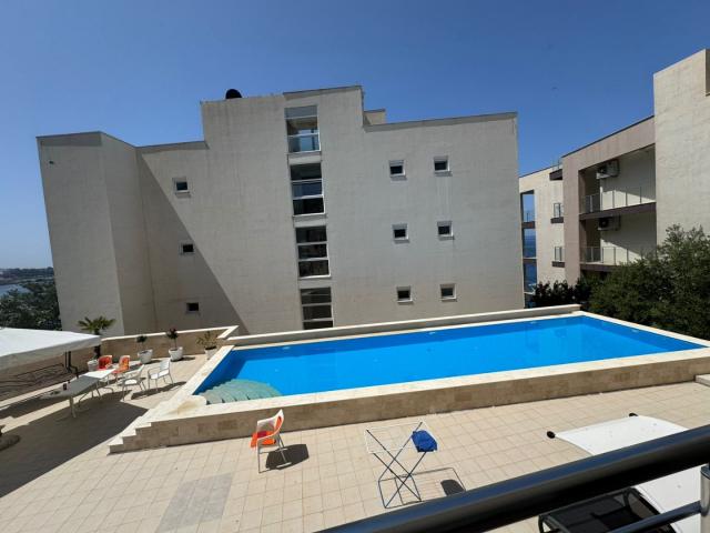 Two-bedroom apartment for sale near the sea in Dobra Voda, in a building with a swimming pool. 