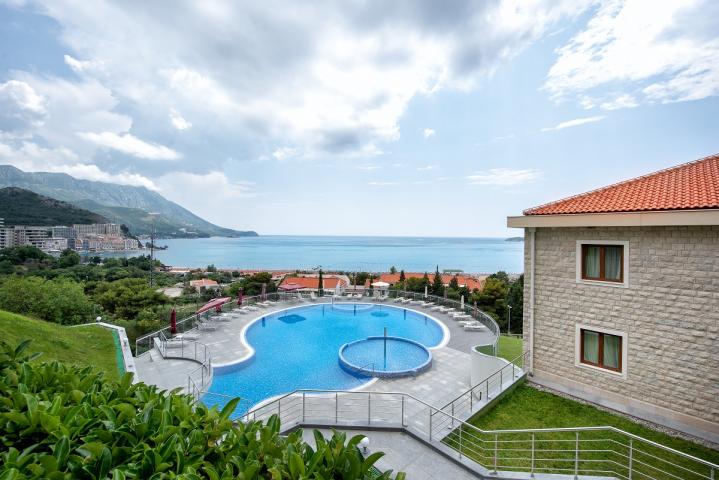 Premium apartment in a residential complex with a swimming pool located in Becici, a suburb of Budva