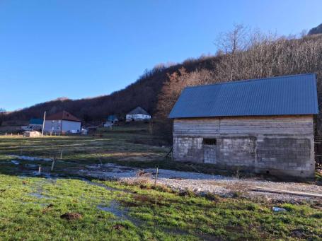Two plots of land on the bank of a stream in Kolasin