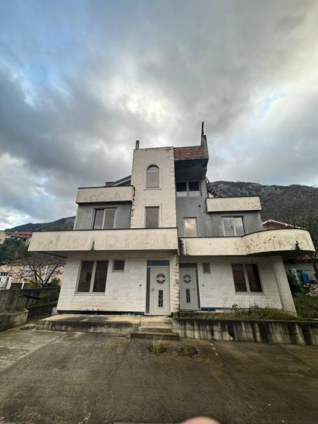 Unfinished house for two townhouses in Prcanj with a project. 